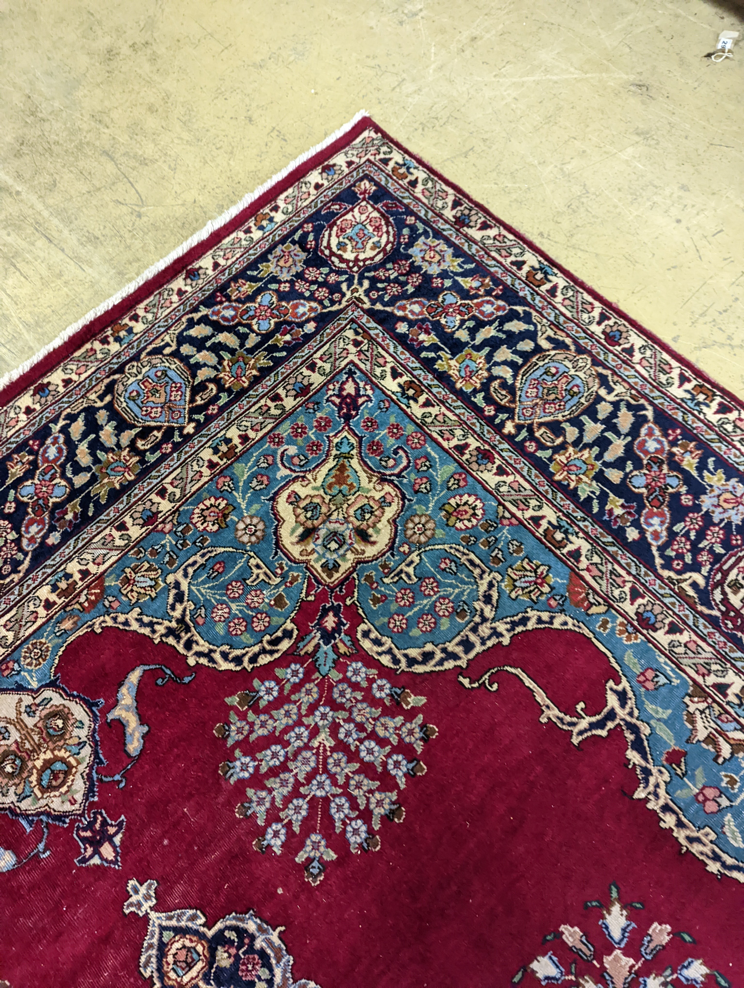 A Tabriz burgundy ground carpet, 350 x 240cm